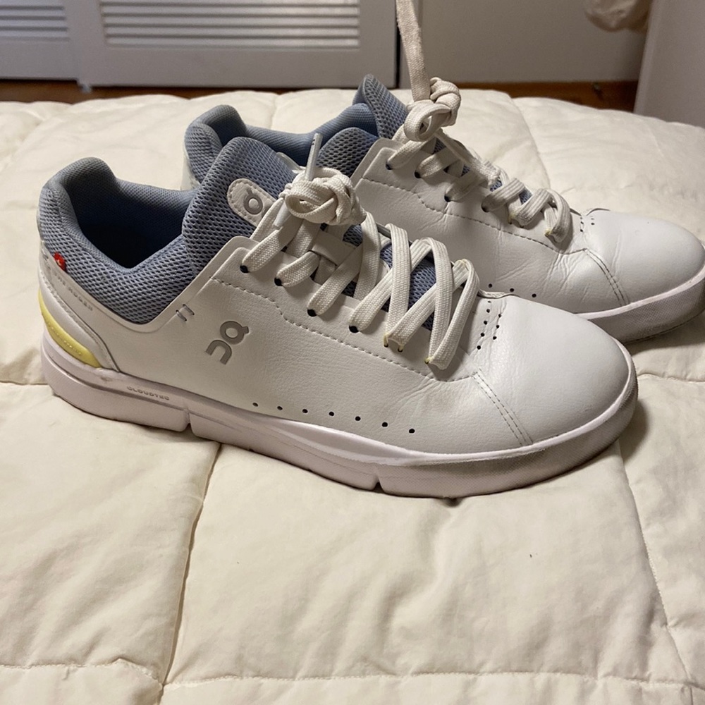 On Running White Sneakers with Light Gray and Pale Yellow Accents